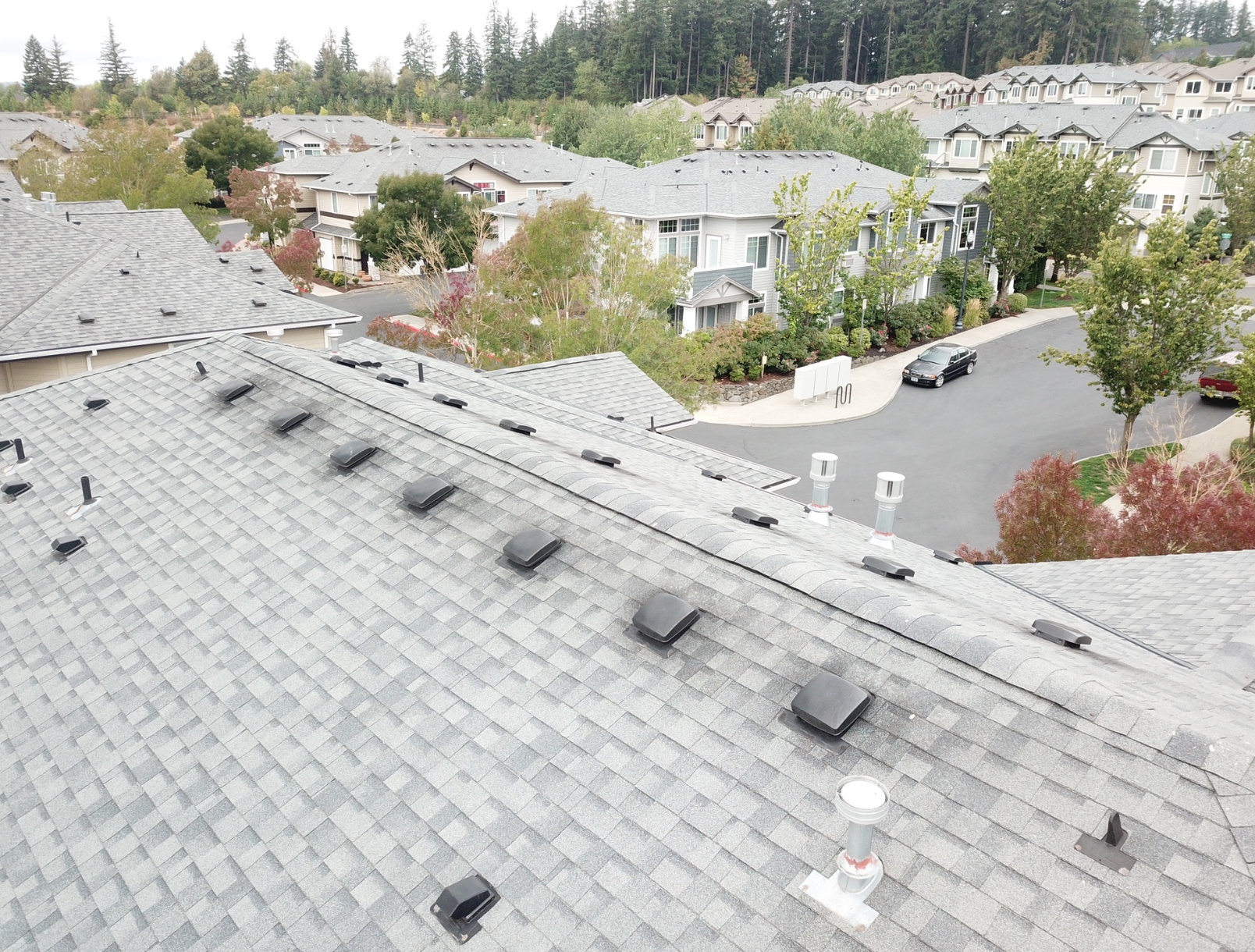 An aerial view of a roof of a house in a residential area