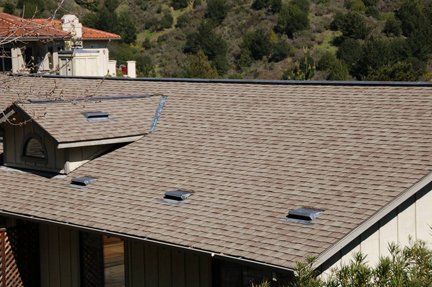 A house with a roof that has a lot of windows on it