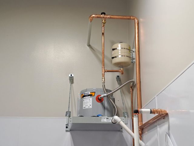 A man is working on a pipe at a construction site.