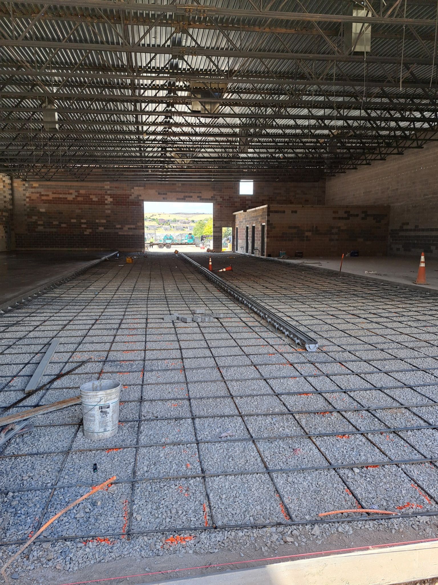 The inside of a building under construction with a concrete floor.
