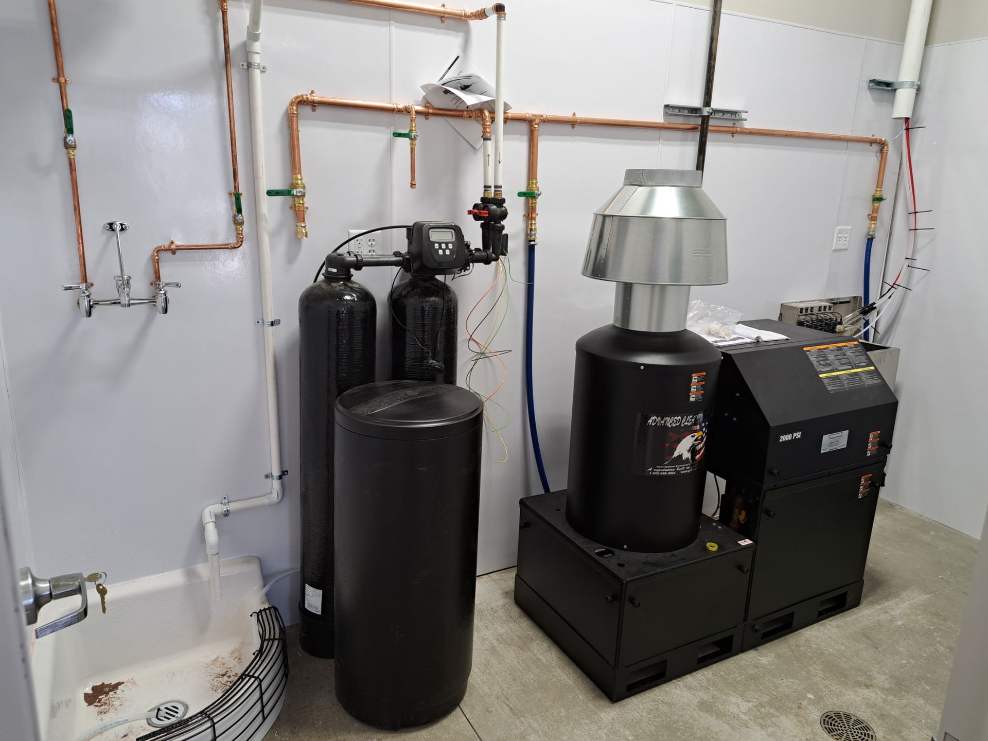 A room with a lot of pipes and a sink