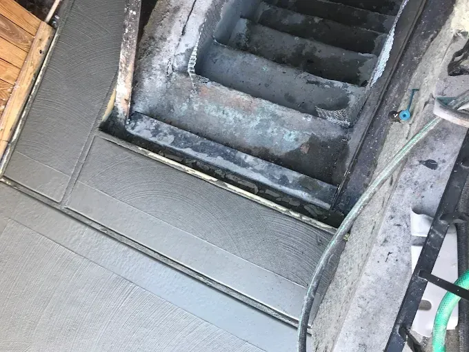 Cement stairs leading down; new cement platform visible at top.