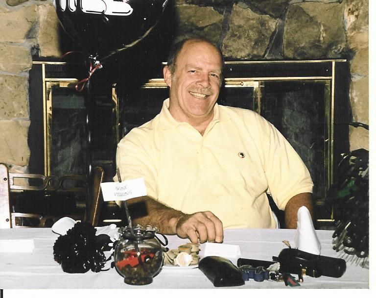 A man in a yellow shirt is sitting at a table