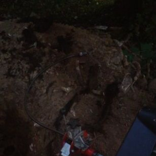 A bunch of wires are laying on the ground in the dark