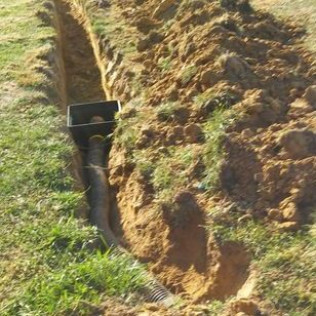 A hole in the ground with a drain in it