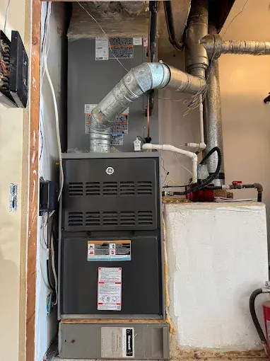 HVAC technician with thumbs up, checking an air conditioning unit with gauges. checking coolant levels. 