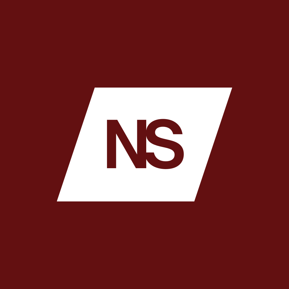 A racehorse with a jockey in green and white winning a race on a turf track.