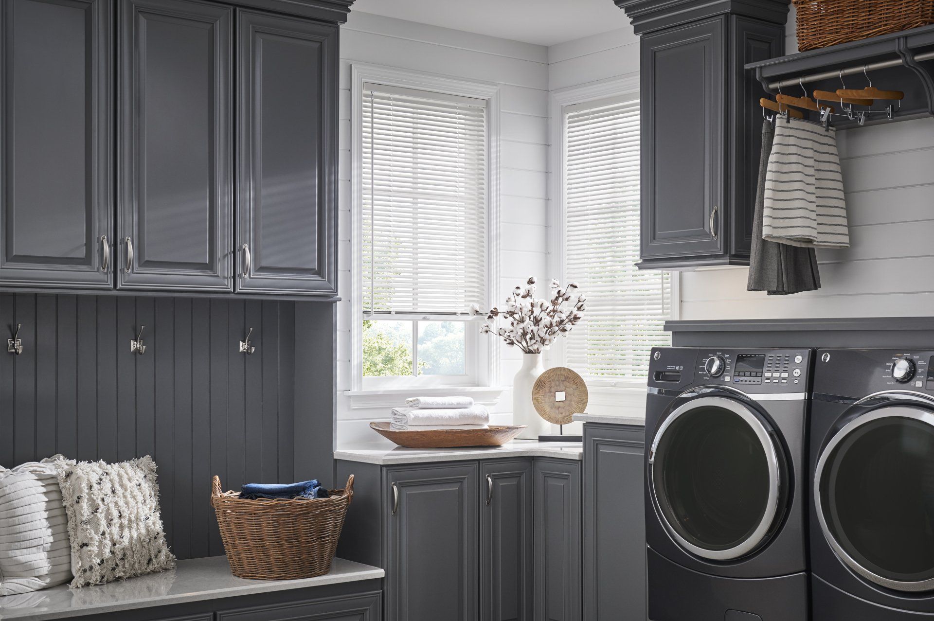 a laundry room with gray cabinets , a washer and dryer , and a window best-custom-made-wood-blinds Georgia.