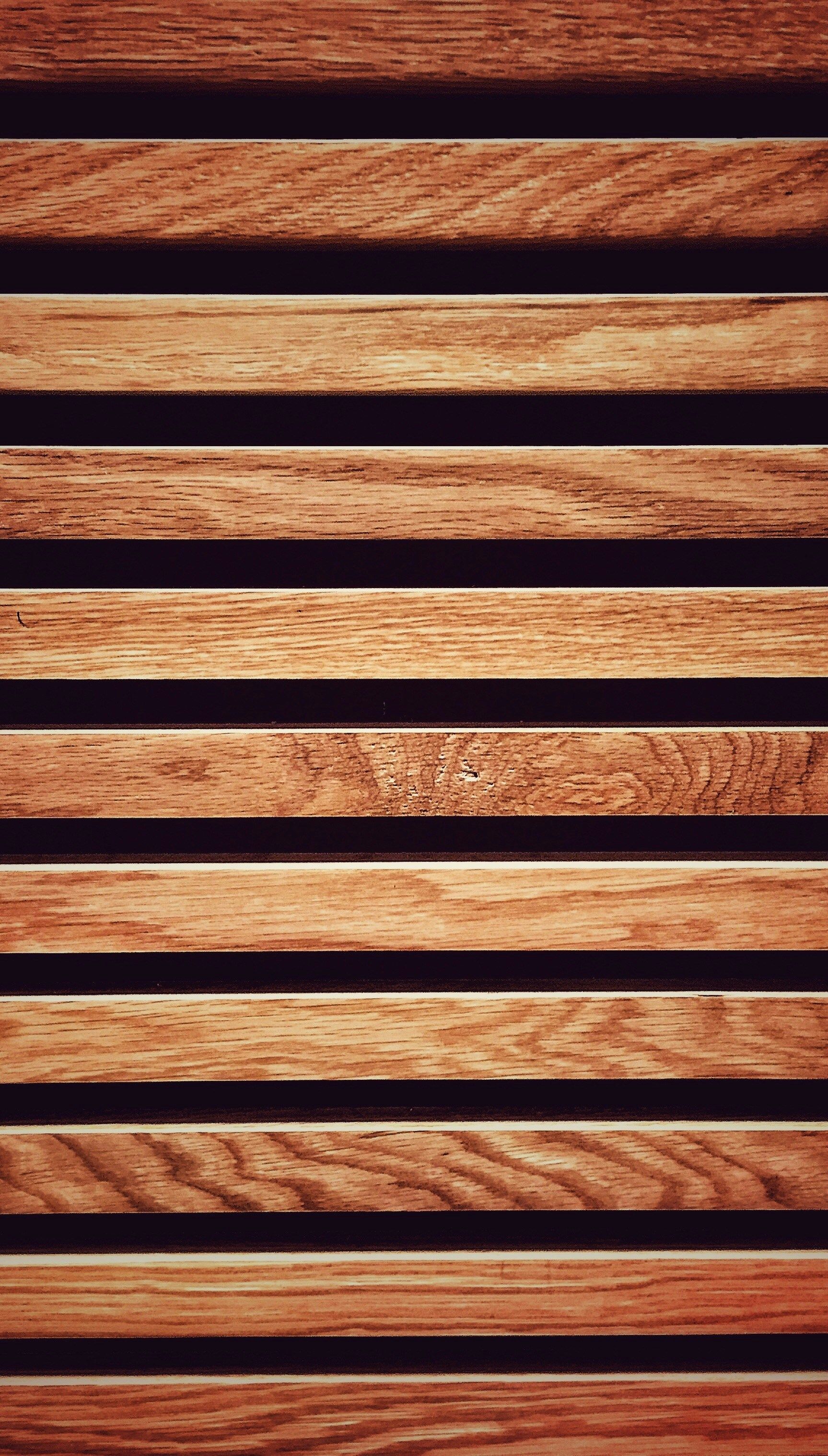 Close-up of horizontal wooden slats, varying shades of brown.