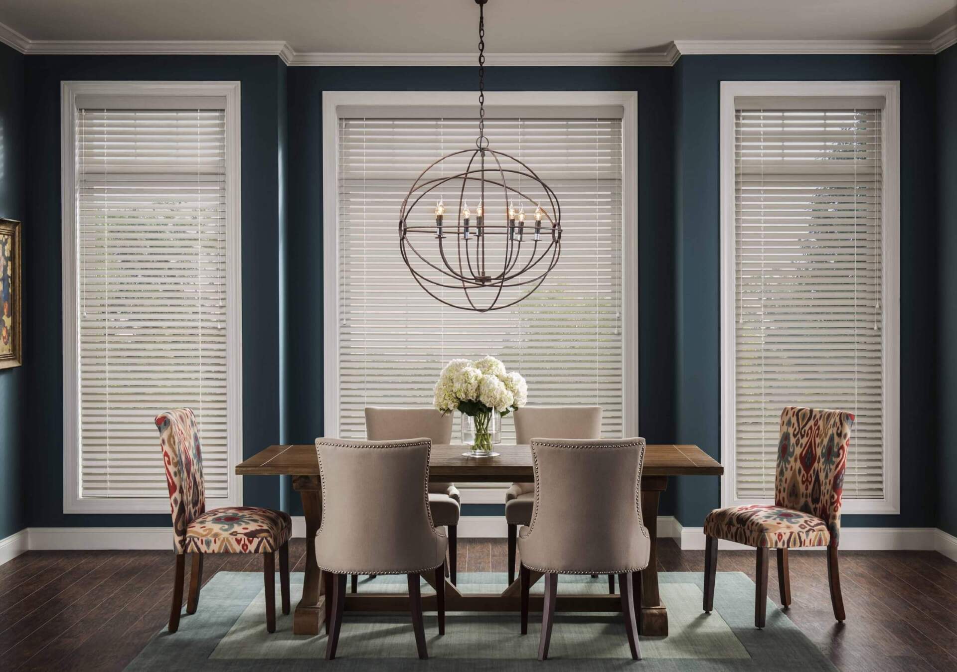 a dining room with a table and chairs and a chandelier custom-window-treatments-in-Love is Blinds Georgia custom blinds installation.