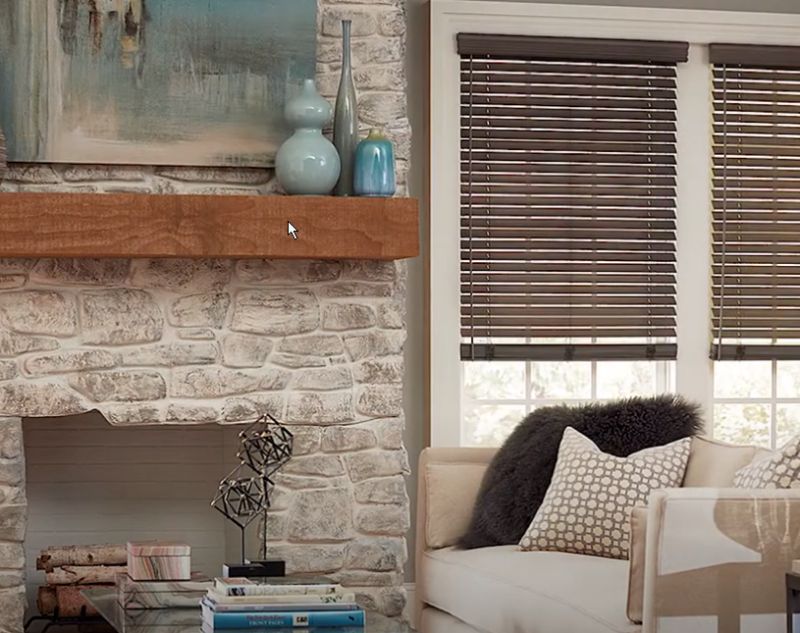 a living room with a fireplace , couch , and cordless operation wooden blinds solutions Love is Blinds Georgia.