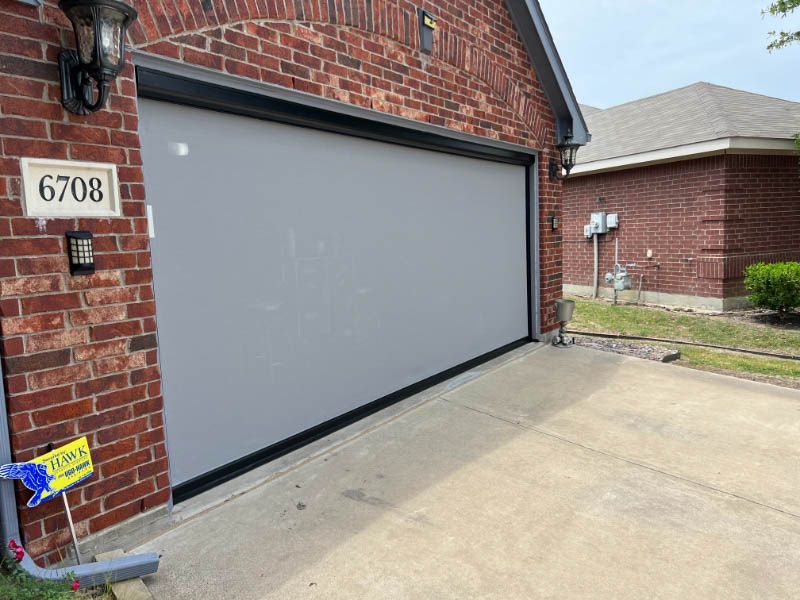 a garage door in front of a brick house exterior patio shades garage Love is Blinds Georgia.