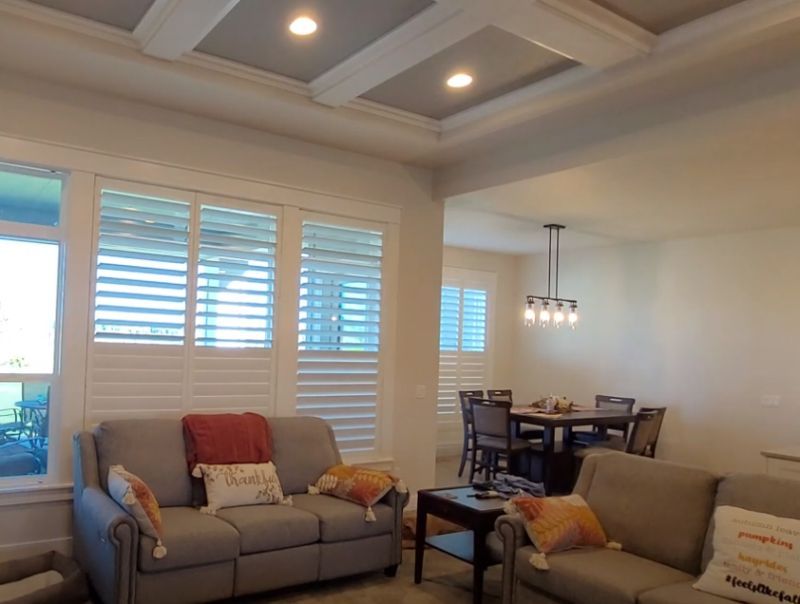 a living room with a couch and a table plantation shutter solutions Love is Blinds Georgia