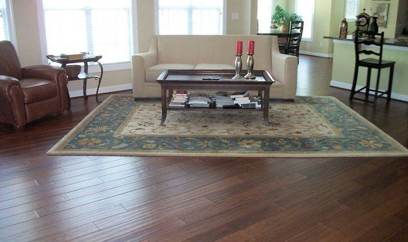 North Carolina Quality Flooring Installation — Furnished Living Room with Wooden Flooring in Matthews, NC