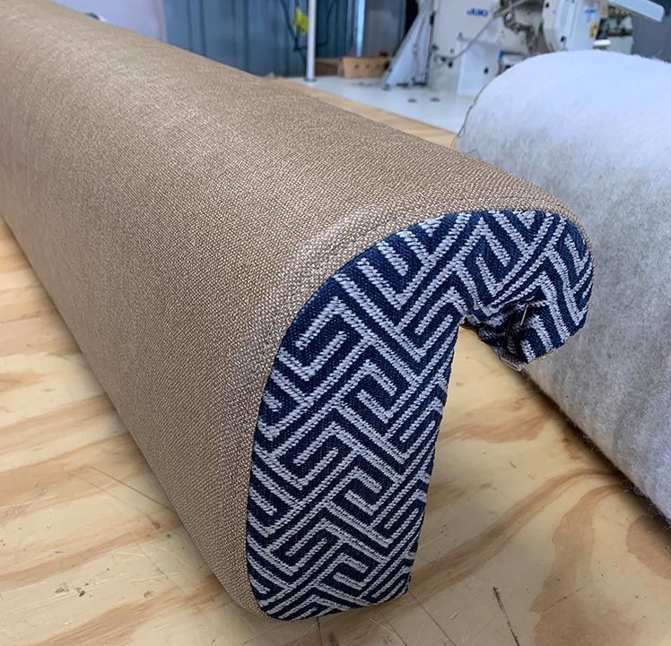 A Piece of Fabric With a Geometric Pattern is on a Wooden Table — Paulie's Upholstery in Edmonton, QLD