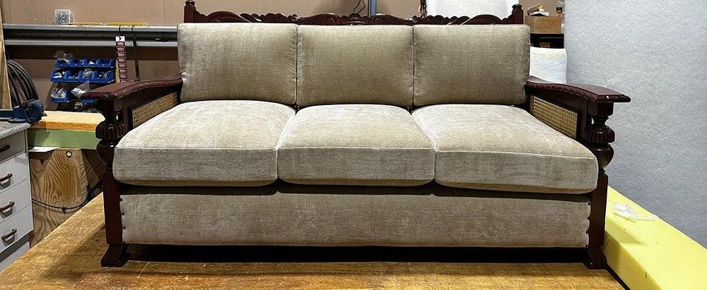 A Couch is on Top of a Wooden Table in a Room — Paulie's Upholstery in Edmonton, QLD