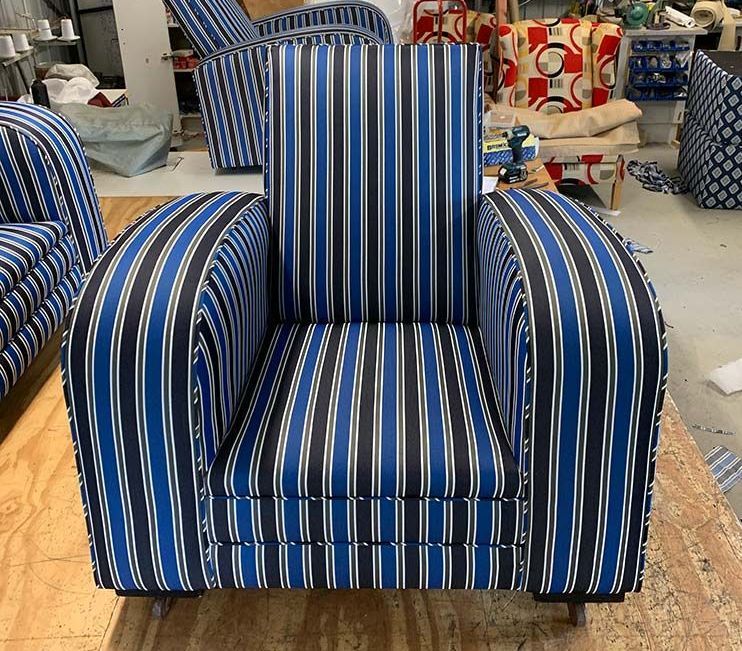 A Blue and Black Striped Chair is in a Room — Paulie's Upholstery in Palm Cove, QLD