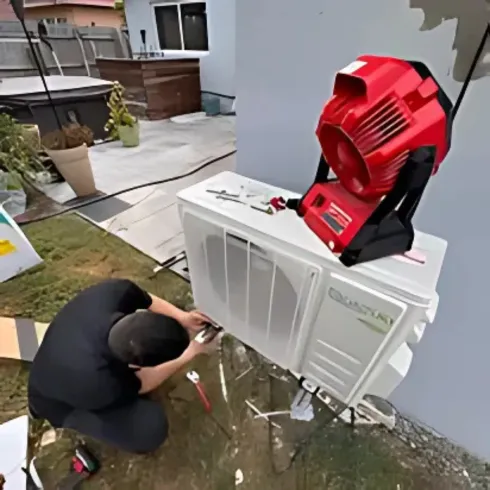 Doctor Air HVAC Corp. -  A man is working on an air conditioner outside of a house