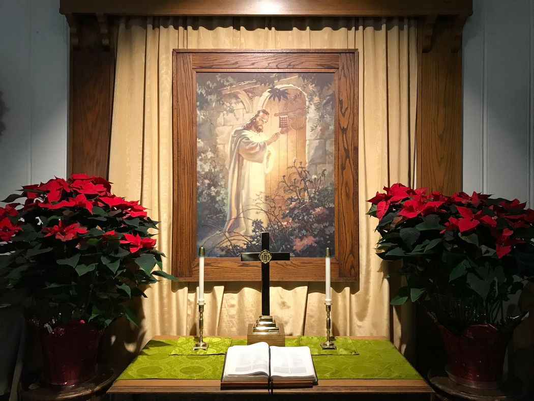A small altar with a picture of Jesus and a cross on it.