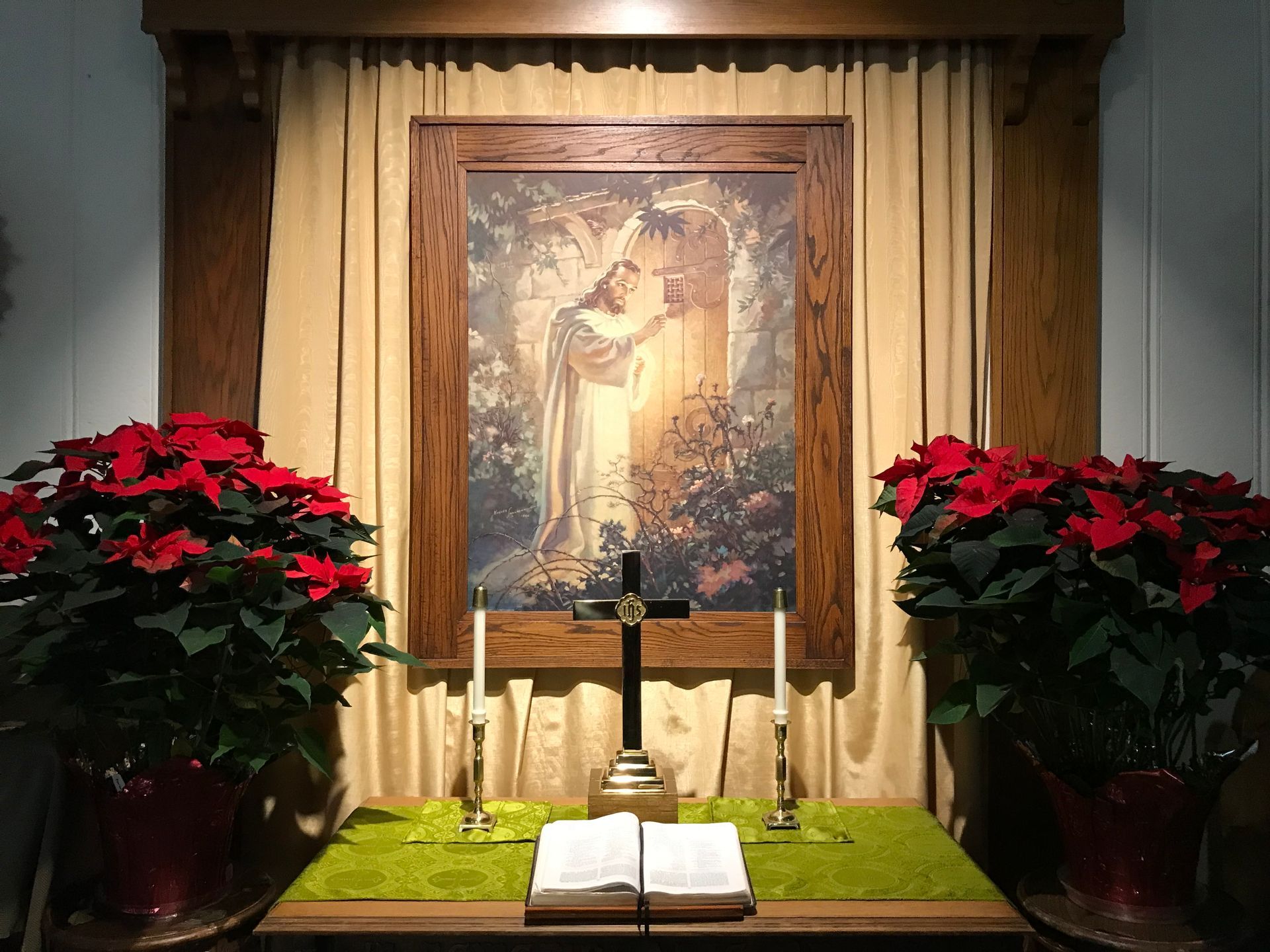A small altar with a picture of Jesus and a cross on it.