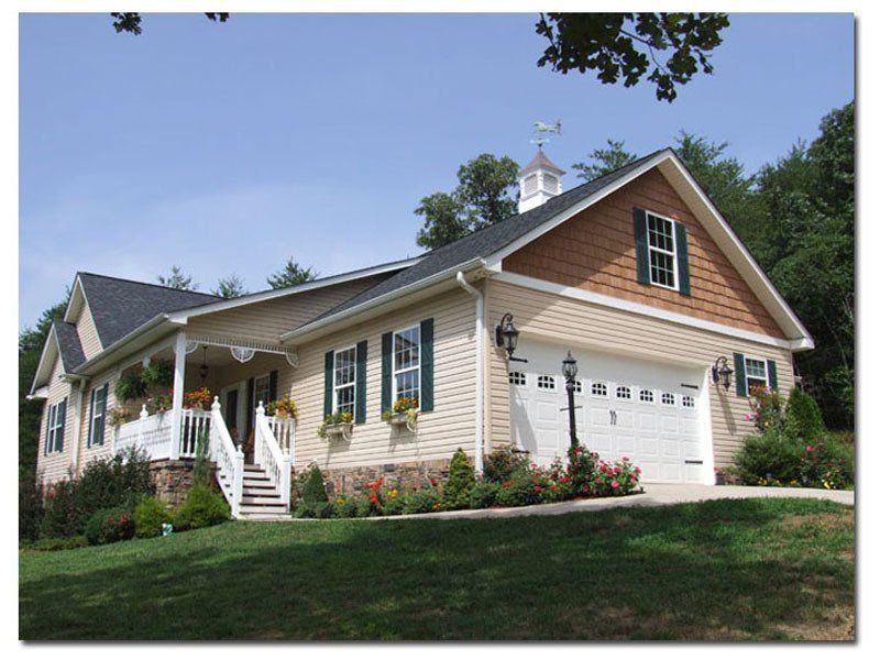 A large house with a large garage and a porch