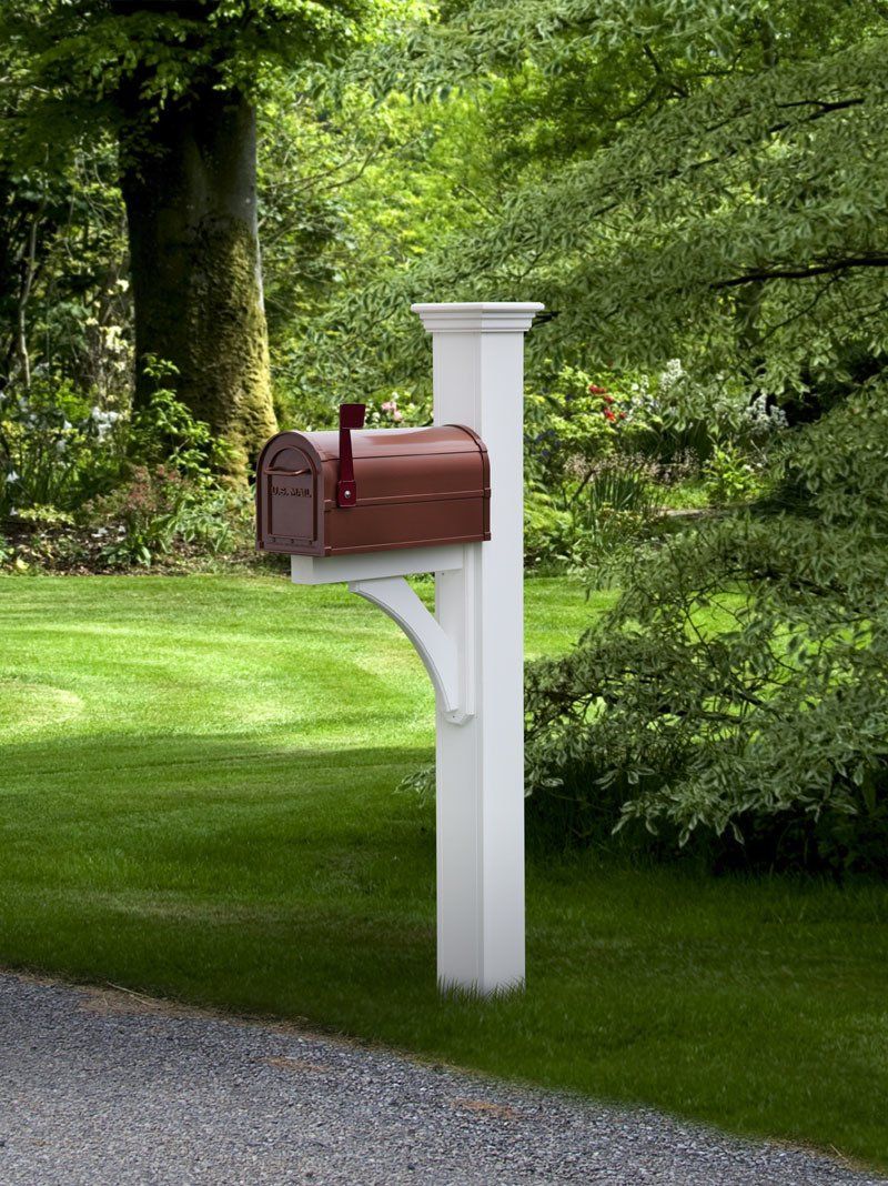 A white post with a red mailbox attached to it.