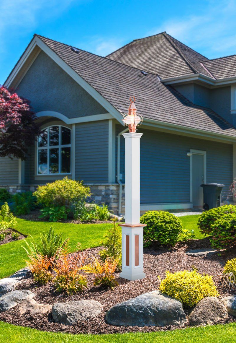 A large house with a white pole in front of it.