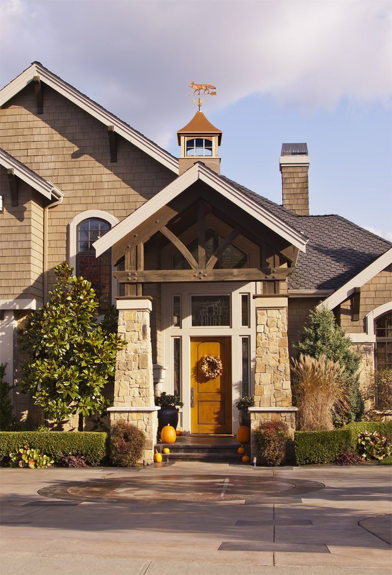 A house with a weather vane on top of it