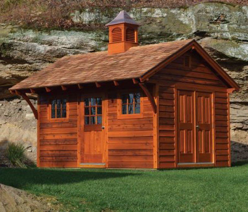 A wooden shed with a chimney on top of it