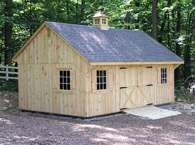A large wooden barn with a black roof