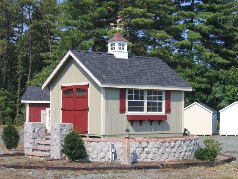 A small shed with a red door and white shutters