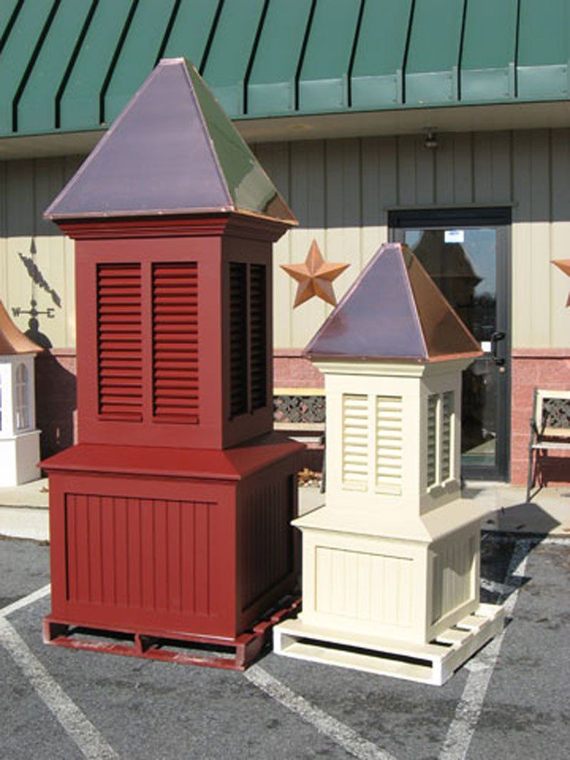 A red and white building with a copper roof