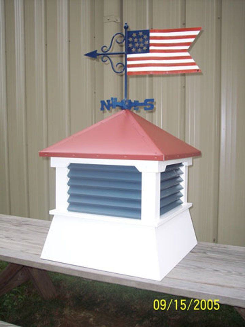 A weather vane with an american flag on top of it