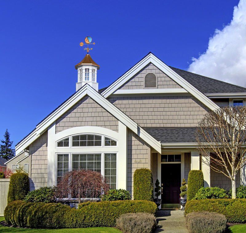 A house with a weather vane on top of it