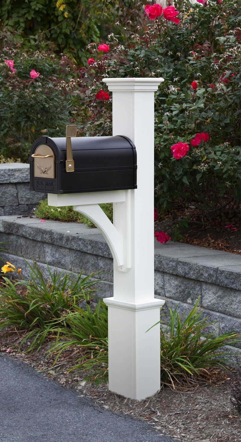 A white post with a black mailbox attached to it.