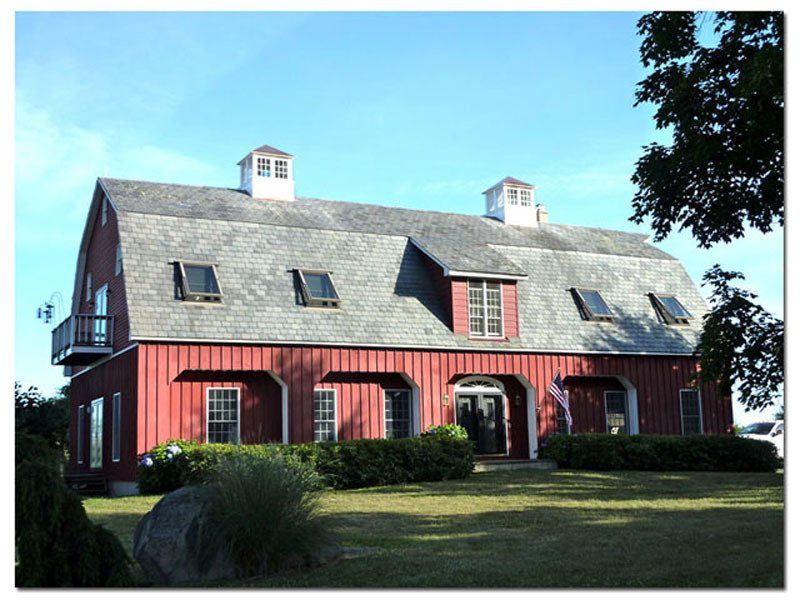 A large red barn with a gray roof
