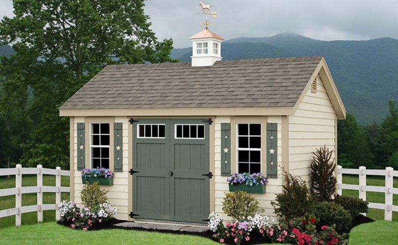 A shed with a weather vane on top of it