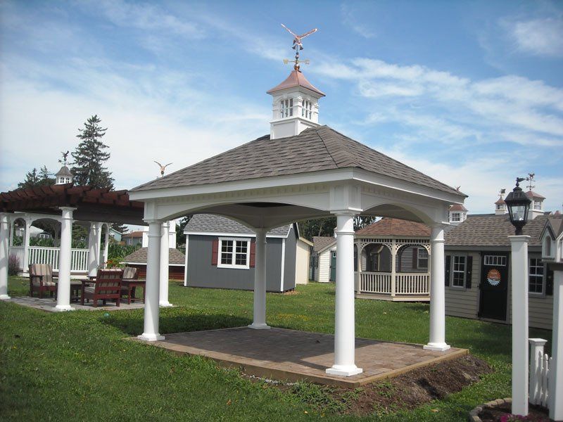A gazebo with a weather vane on top of it