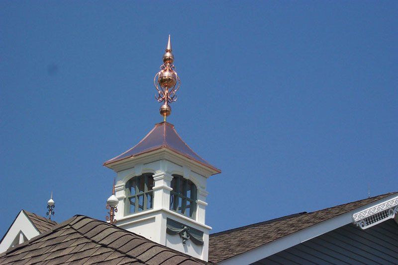 A clock tower on top of a building with a blue sky in the background