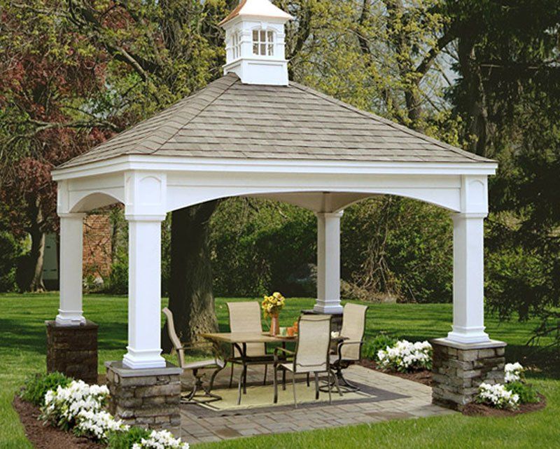 A gazebo with a table and chairs underneath it