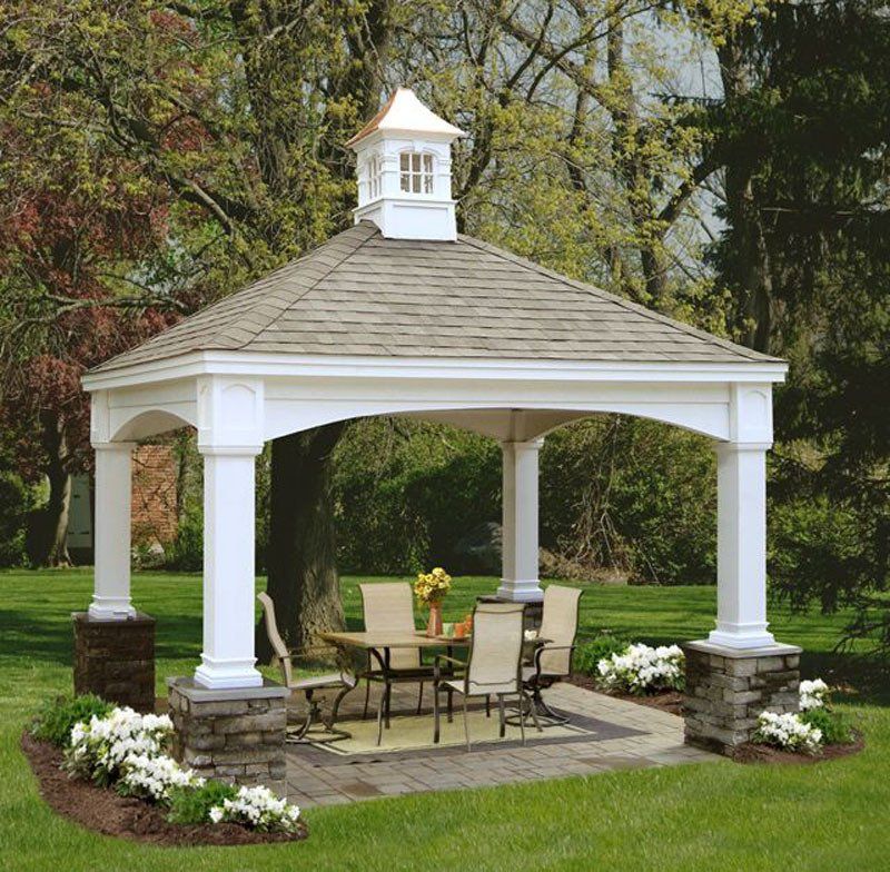 A gazebo with a table and chairs underneath it