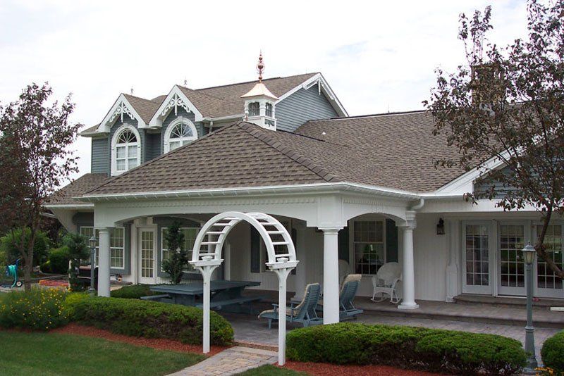 A large white house with a porch and a roof
