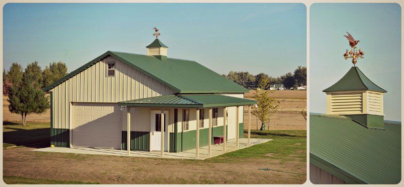 A white barn with a green roof and a weather vane on top
