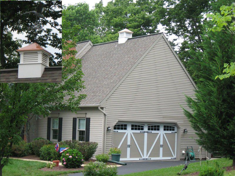 A house with a garage and a chimney on the roof