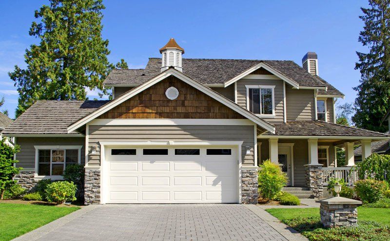A large house with a large white garage door
