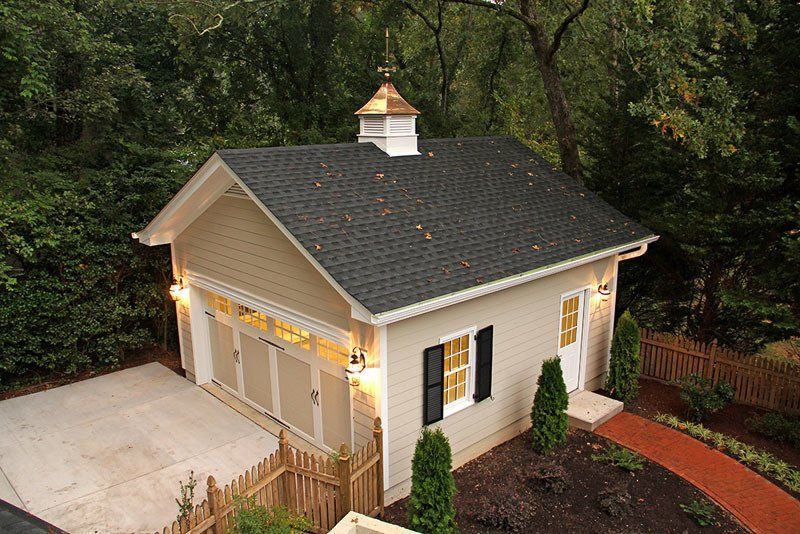 An aerial view of a small house with a black roof