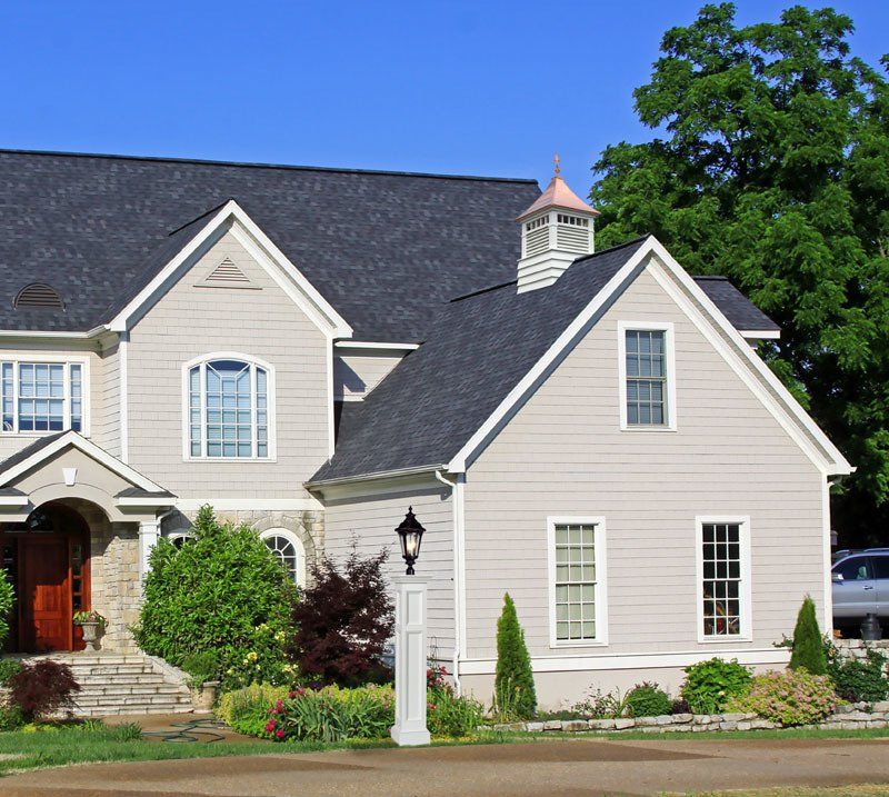 A large white house with a black roof