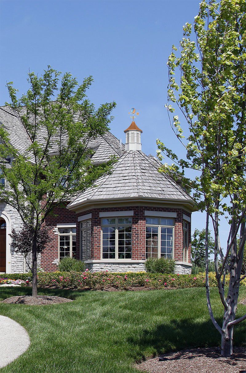 A brick house with a gazebo on top of it