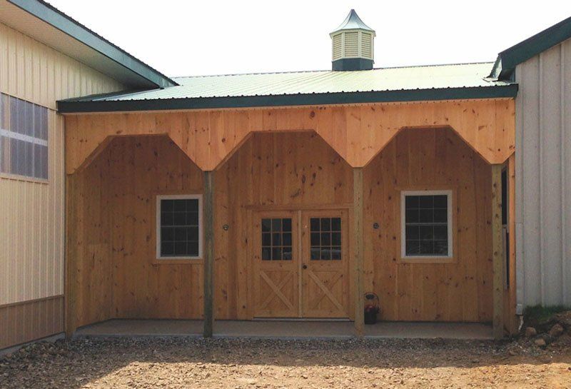 A large wooden building with a green roof