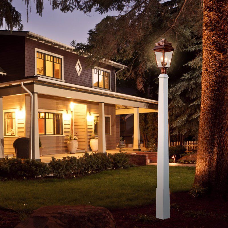 A house with a porch and a lamp post in front of it